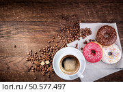 coffee  beans donut on a wooden table. Стоковое фото, агентство Ingram Publishing / Фотобанк Лори