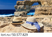 two hats at Azure Window in Gozo island, vacation in Malta concept. two hats at Azure Window on Gozo island, vacation in Malta. Стоковое фото, агентство Ingram Publishing / Фотобанк Лори