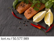 Delicious portion of fresh salmon fillet with aromatic herbs, spices and vegetables . Стоковое фото, агентство Ingram Publishing / Фотобанк Лори