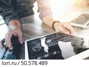 Website designer working digital tablet and computer laptop and digital design diagram on wooden desk as concept. Стоковое фото, агентство Ingram Publishing / Фотобанк Лори