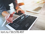 Website designer working digital tablet and computer laptop and digital design diagram on wooden desk as concept. Стоковое фото, агентство Ingram Publishing / Фотобанк Лори