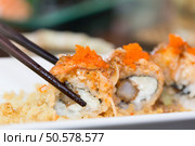Sushi salmon roll with chopstick. Стоковое фото, агентство Ingram Publishing / Фотобанк Лори