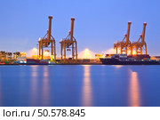 Container stacks and crane in shipyard at dusk for cargo Goods and Logistic background. Стоковое фото, агентство Ingram Publishing / Фотобанк Лори