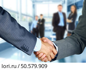 Business associates shaking hands in office . Стоковое фото, агентство Ingram Publishing / Фотобанк Лори