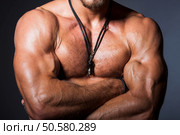 Muscular and sexy torso of young sporty man showing his perfect bicep and body. Muscular and sexy torso of young sporty man showing his perfect bicep, shoulders, chest. Стоковое фото, агентство Ingram Publishing / Фотобанк Лори