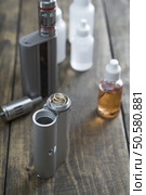 E-cigarettes with lots of different re-fill bottles, close up. Стоковое фото, агентство Ingram Publishing / Фотобанк Лори