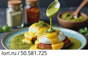 A close-up of a spoonful of matcha-infused hollandaise sauce drizzling over eggs Benedict, green and yellow hues contrasting beautiful kitchen background. Стоковое AI-видео, аниматор Sergey Grishin / Фотобанк Лори
