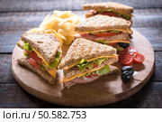 Group of club sandwiches with potato chips on wooden bacground,selective focus . Стоковое фото, агентство Ingram Publishing / Фотобанк Лори