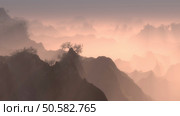 High altitude view of rugged forested mountain peaks with mist at dawn stretching into the distance lit by the glow of the rising sun. Forested mountain peaks with mist at dawn. Стоковое фото, агентство Ingram Publishing / Фотобанк Лори