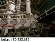 Pipes, tubes, machinery and steam turbine at a power plant               . Стоковое фото, агентство Ingram Publishing / Фотобанк Лори