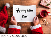Santa Claus holding an empty wish list in his hands. Santa Claus and wishlist. Стоковое фото, агентство Ingram Publishing / Фотобанк Лори