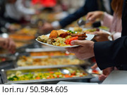 people group catering buffet food indoor in luxury restaurant with meat colorful fruits  and vegetables. Стоковое фото, агентство Ingram Publishing / Фотобанк Лори