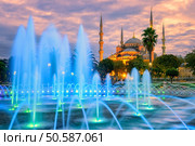 Blue Mosque (Sultanahmet camii) with blue illuminated fountain in the city center of Istanbul, Turkey. Стоковое фото, агентство Ingram Publishing / Фотобанк Лори