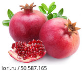 Juicy pomegranates and its section. Isolated on a white background. . Juicy pomegranates and its section.Isolated on a white background. . Стоковое фото, агентство Ingram Publishing / Фотобанк Лори