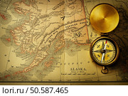 Antique brass compass over old XIX century map. Стоковое фото, агентство Ingram Publishing / Фотобанк Лори