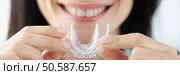 Woman holding plastic mouth guard for bruxism treatment closeup. Correction of bite concept. Woman holding plastic mouth guard for bruxism treatment closeup. Стоковое фото, агентство Ingram Publishing / Фотобанк Лори
