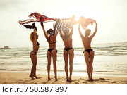 Woman with beautiful figures wearing bikinis at the beach. Стоковое фото, агентство Ingram Publishing / Фотобанк Лори