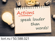 Actions Speak Louder Than Words text on notebook with many light bulbs. Стоковое фото, агентство Ingram Publishing / Фотобанк Лори