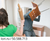 Fight between married couple. Wife and her husband are attacking each other. Стоковое фото, агентство Ingram Publishing / Фотобанк Лори