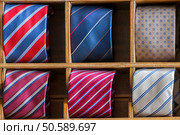 different colors silk tie on display stand. Стоковое фото, агентство Ingram Publishing / Фотобанк Лори