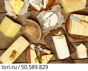 Various types of cheese on rustic background. Стоковое фото, агентство Ingram Publishing / Фотобанк Лори