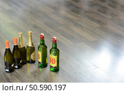 Bottles of wine, champagne and whiskey placed on the floor. Стоковое фото, агентство Ingram Publishing / Фотобанк Лори