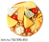 Board with assortment of delicious cheese, tomatoes and nuts on white background. Стоковое фото, агентство Ingram Publishing / Фотобанк Лори