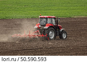 Small scale farming with tractor and plow in field . Стоковое фото, агентство Ingram Publishing / Фотобанк Лори