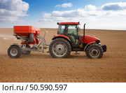 Small scale farming with tractor and plow in field. Agricultural landscape. Стоковое фото, агентство Ingram Publishing / Фотобанк Лори