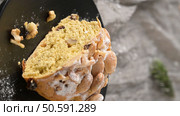 A delicious slice of Bolo Rainha cake with nuts raisins and powdered sugar on a black plate a festive treat perfect for sharing and enjoying during special occasions. Стоковое фото, агентство Ingram Publishing / Фотобанк Лори