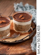 Savor a delectable tiramisu-inspired chia pudding, layered with creamy coffee-infused chia and a decadent chocolate topping. This guilt-free breakfast or dessert blends classic flavors with wholesome ingredients for a convenient and satisfying treat. Стоковое фото, агентство Ingram Publishing / Фотобанк Лори