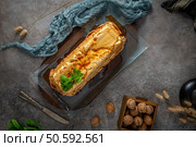 A top-down view showcases a whole molotof, a traditional caramelized egg white pudding, generously drizzled with sweet syrup and garnished with fresh mint on a glass platter. Стоковое фото, агентство Ingram Publishing / Фотобанк Лори