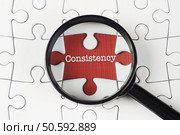 "Consistency" text on missing puzzle with magnifying glass on it searching for missing puzzle peace. "consistency",Text,On,Missing,Puzzle,With,Magnifying,Glass,On,It. Стоковое фото, агентство Ingram Publishing / Фотобанк Лори