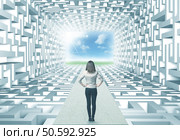 Successful businesswoman in front of a complicated labyrinth. Стоковое фото, агентство Ingram Publishing / Фотобанк Лори