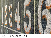 Numbers one through six painted on lanes of weathered track. Стоковое фото, агентство Ingram Publishing / Фотобанк Лори