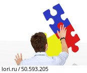 business man making a jigsaw puzzle isolated. Стоковое фото, агентство Ingram Publishing / Фотобанк Лори