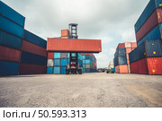 Cargo container for overseas shipping in shipyard with heavy machine . Logistics supply chain management and international goods export concept .. Cargo container for overseas shipping in shipyard with heavy machine . Стоковое фото, агентство Ingram Publishing / Фотобанк Лори