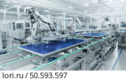 Wide Shot of Solar Panel Production Line with Robot Arms at Modern Bright Factory. Solar Panels are being Assembled on Conveyor. Стоковое фото, агентство Ingram Publishing / Фотобанк Лори