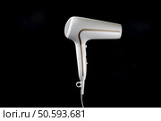 Professional stylish hairdryer isolated over a black background. White Ionic Hair Dryer with Hair Care Tool.. Professional stylish hairdryer isolated over a black background. White Ionic Hair Dryer. Modern Blow Dryer. Стоковое фото, агентство Ingram Publishing / Фотобанк Лори
