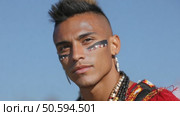 Indigenous man wearing traditional clothes and face paint. Стоковое AI-видео, аниматор Юрий Поздников / Фотобанк Лори