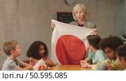in geography lesson, students carefully listen to woman teacher who talks about Japan. Стоковое видео, видеограф Яков Филимонов / Фотобанк Лори