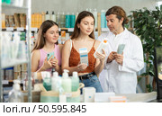 Woman with teen girl choosing and scan QR code cream at pharmacy. Стоковое фото, фотограф Яков Филимонов / Фотобанк Лори