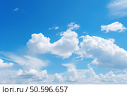 Bright blue sky with fluffy white clouds creating a peaceful atmosphere. Стоковое AI-изображение, AI-художник Иван Рябоконь / Фотобанк Лори