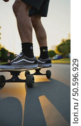 Low perspective shot of male feet in sneakers or skating shoes ride longboard and swerve on pavement. Cool extreme sport lifestyle or transportation mode. Стоковое AI-видео, аниматор Sergey Grishin / Фотобанк Лори