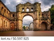 Porta nigra roman city gate arch trier germany cloudy sky. Стоковое AI-изображение, AI-художник Иван Рябоконь / Фотобанк Лори