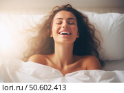 Happy woman waking up in bed smiling and feeling refreshed. Стоковое AI-изображение, AI-художник Иван Рябоконь / Фотобанк Лори