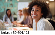 Smiling woman participates in team discussion during a collaborative work session in an office setting. Стоковое AI-изображение, AI-художник Сергей Толмачёв / Фотобанк Лори