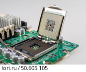 the process of connecting the CPU to the processor socket on a modern computer motherboard, replacing the silicon data processing chip, and correctly installing the central processing unit. Стоковое фото, агентство Ingram Publishing / Фотобанк Лори