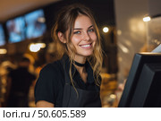 Smiling cashier assists customers in busy retail store while colleagues work. Улыбчивый кассир обслуживает покупателей в оживленном розничном магазине, пока коллеги работают. Стоковое AI-изображение, AI-художник Katsiaryna Repich / Фотобанк Лори