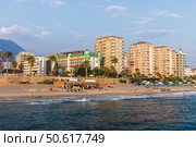 Mahmutlar, Turkey. Colorful beachfront buildings beside a sandy beach (2024 год). Редакционное фото, фотограф EugeneSergeev / Фотобанк Лори